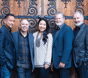 Joyce Yang and Alexander String Quartet in front a wooden church door with ornate metalwork